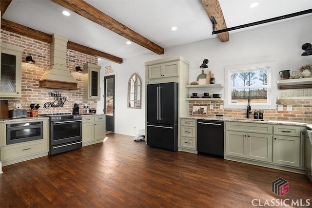 kitchen with premium range hood, sink, green cabinets, and black appliances