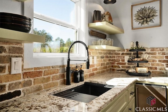 kitchen with light stone counters and sink