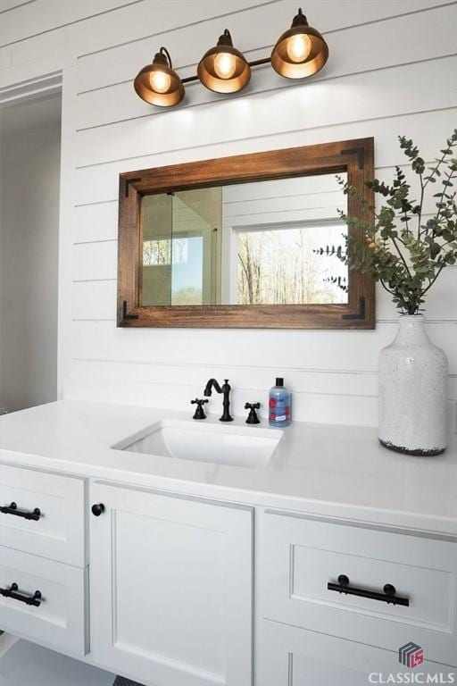 bar with white cabinetry and sink