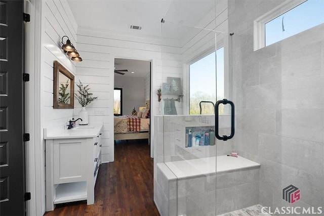 bathroom featuring wood-type flooring, vanity, and a shower with shower door