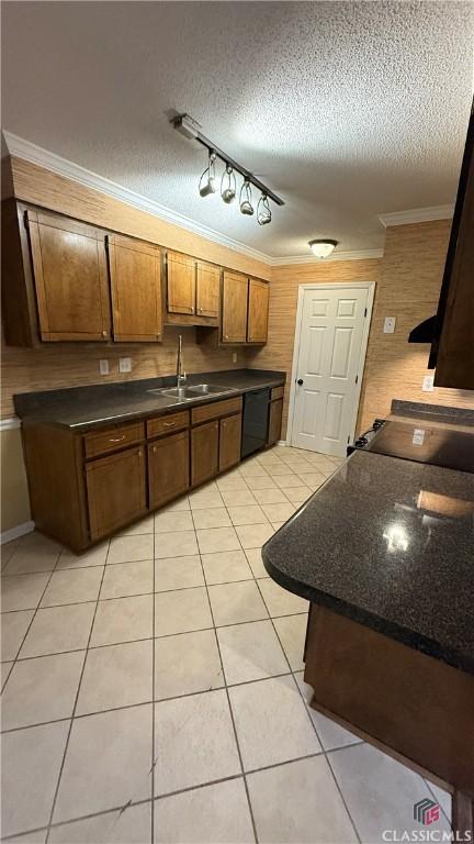 kitchen featuring sink, a textured ceiling, light tile patterned floors, ornamental molding, and black dishwasher