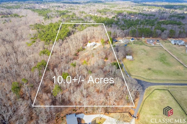 birds eye view of property with a rural view