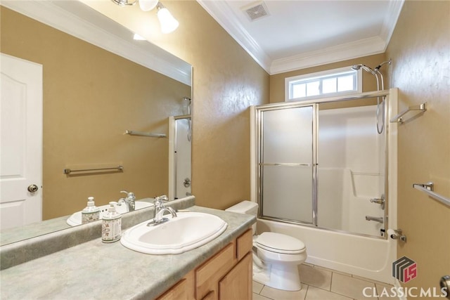 full bathroom with bath / shower combo with glass door, tile patterned flooring, ornamental molding, vanity, and toilet