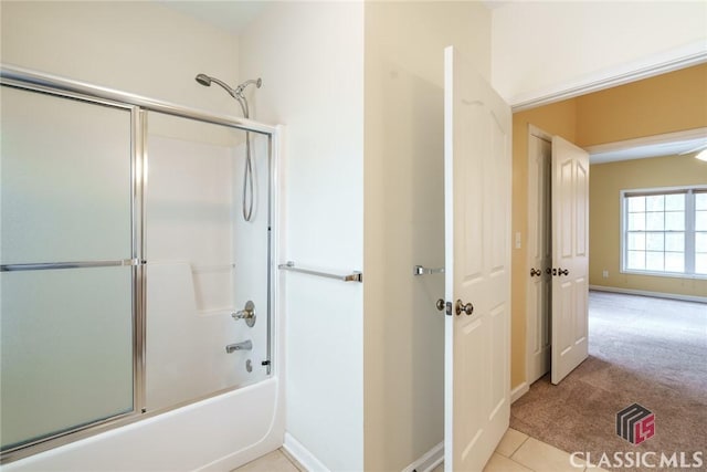 bathroom with tile patterned floors and combined bath / shower with glass door