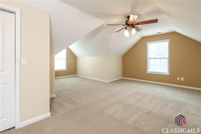 bonus room featuring ceiling fan, light colored carpet, and vaulted ceiling