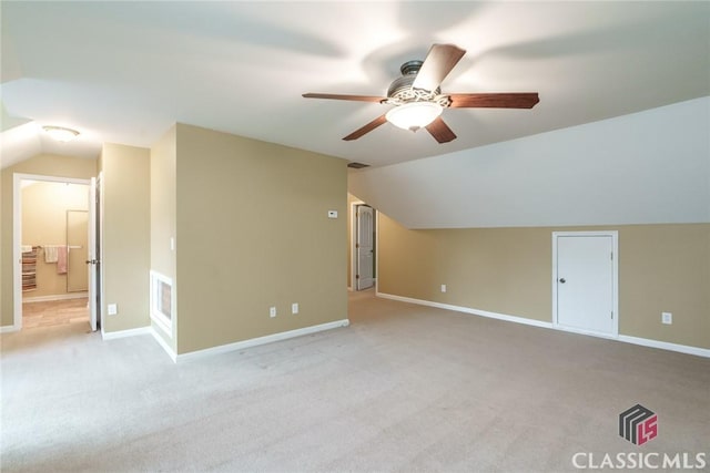 bonus room featuring lofted ceiling, light carpet, and ceiling fan