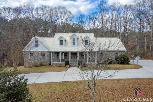 cape cod home with a front yard