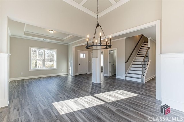 foyer entrance with crown molding, dark hardwood / wood-style floors, and a raised ceiling