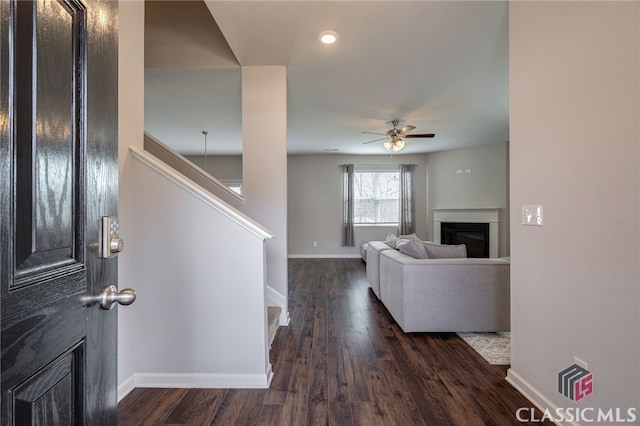 living room featuring dark hardwood / wood-style floors and ceiling fan