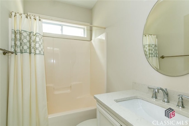 full bathroom with vanity, shower / bathtub combination with curtain, and toilet