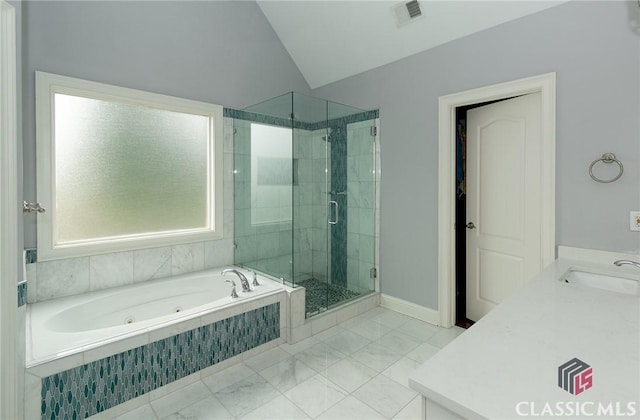 bathroom featuring lofted ceiling, vanity, and separate shower and tub