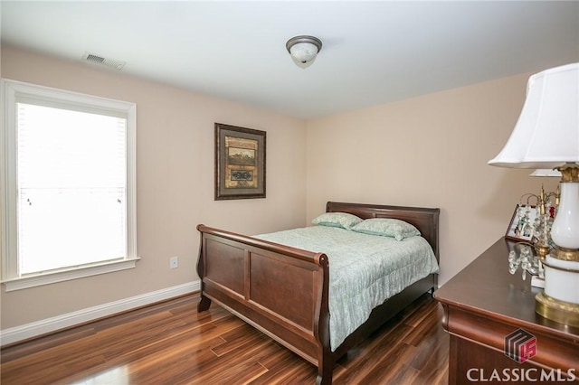 bedroom with dark wood-type flooring