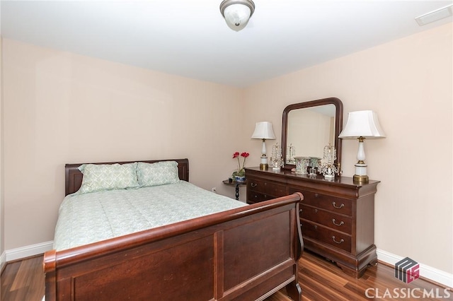 bedroom with dark wood-type flooring