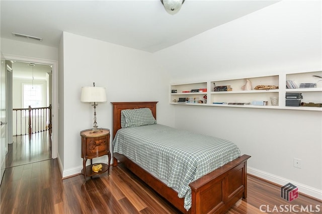 bedroom with dark hardwood / wood-style flooring