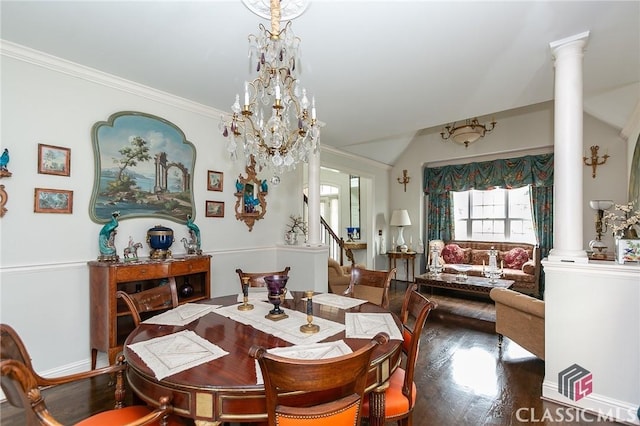 dining room with lofted ceiling, hardwood / wood-style floors, a notable chandelier, ornamental molding, and ornate columns