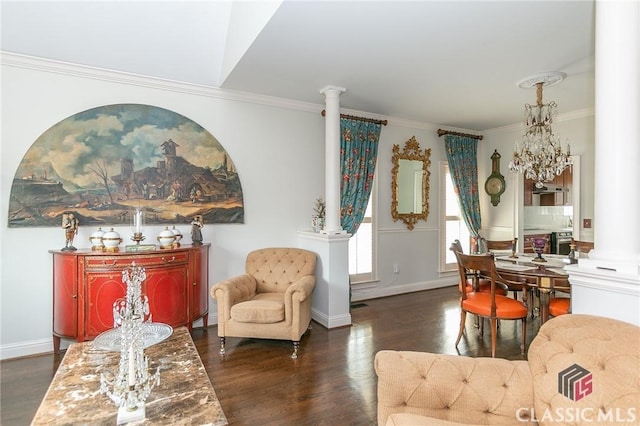 living area featuring crown molding, dark hardwood / wood-style floors, and decorative columns