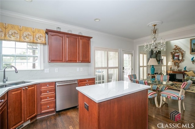 kitchen featuring pendant lighting, sink, dark hardwood / wood-style flooring, a center island, and stainless steel dishwasher