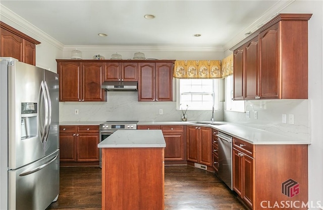 kitchen with a kitchen island, appliances with stainless steel finishes, sink, backsplash, and dark wood-type flooring