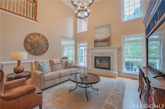 living room with an inviting chandelier, hardwood / wood-style floors, and plenty of natural light