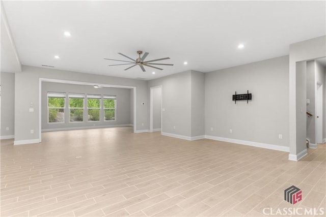 unfurnished living room featuring ceiling fan and light hardwood / wood-style floors