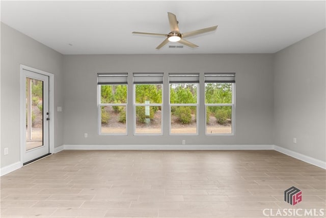 spare room with ceiling fan and light hardwood / wood-style flooring