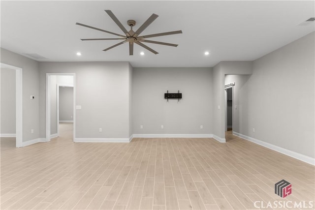 spare room with ceiling fan and light wood-type flooring