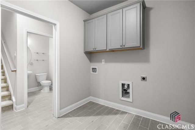 clothes washing area with cabinets, washer hookup, and hookup for an electric dryer