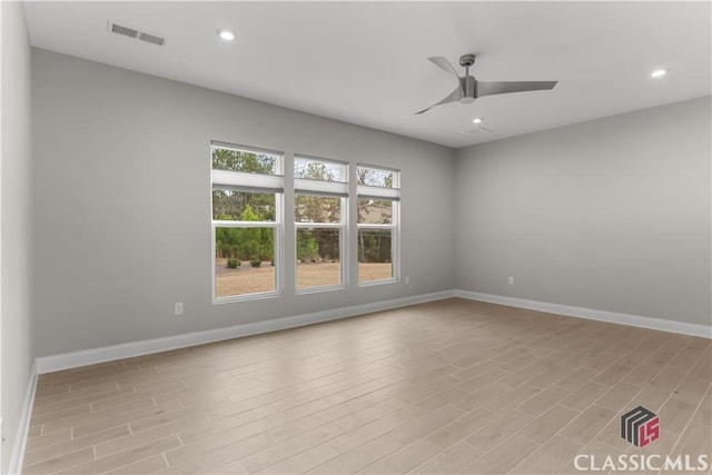 empty room with light hardwood / wood-style flooring and ceiling fan