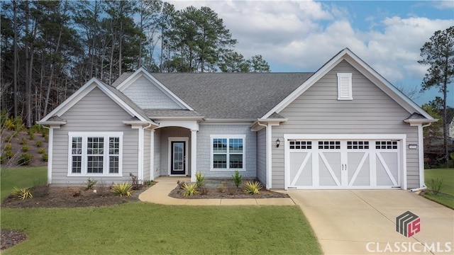 view of front of home featuring a garage and a front lawn