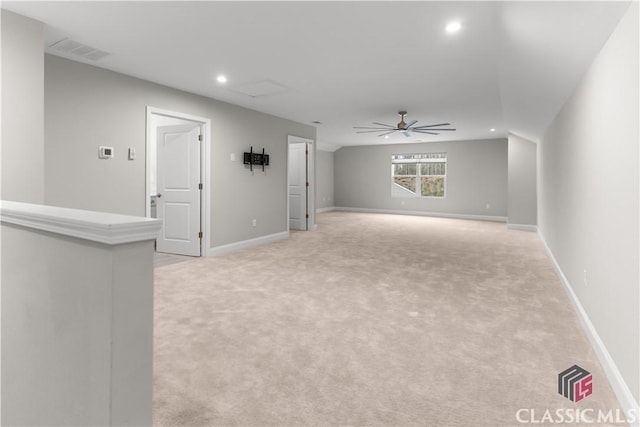 unfurnished living room featuring ceiling fan and light carpet