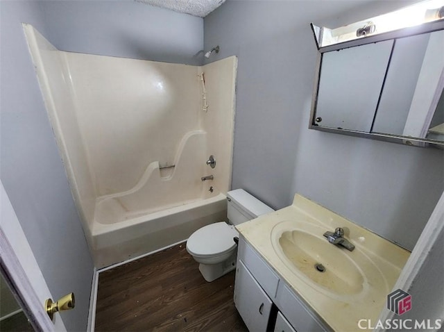 full bathroom featuring hardwood / wood-style flooring, vanity, toilet, and shower / bathing tub combination