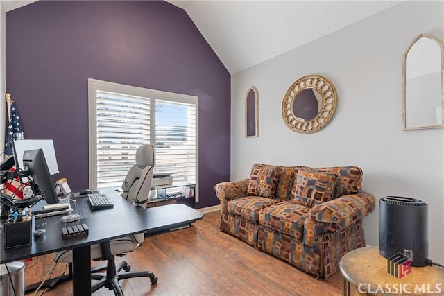 home office featuring high vaulted ceiling and hardwood / wood-style floors