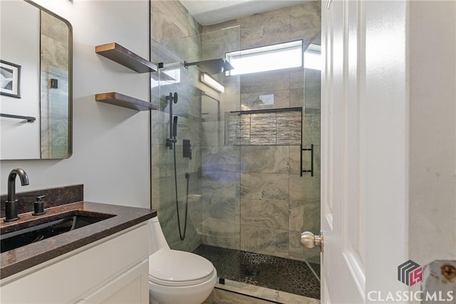 bathroom with walk in shower, vanity, and toilet