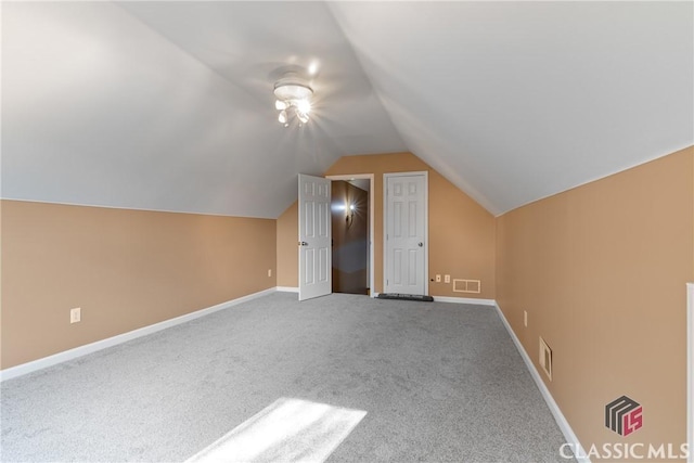 bonus room featuring vaulted ceiling and carpet flooring