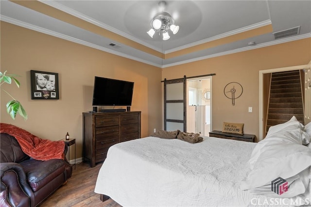 bedroom with wood-type flooring, ornamental molding, a barn door, and ceiling fan