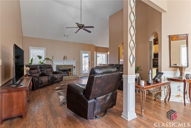 living room featuring hardwood / wood-style flooring, a fireplace, high vaulted ceiling, and a wealth of natural light