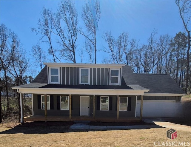 view of front of property with board and batten siding, concrete driveway, an attached garage, and covered porch