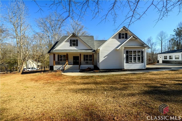 view of front of house with a porch and a front lawn