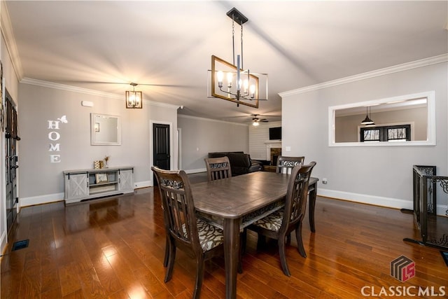 dining room featuring ornamental molding, dark hardwood / wood-style floors, and ceiling fan with notable chandelier