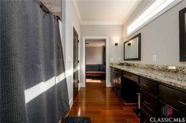 bathroom featuring crown molding, vanity, and curtained shower