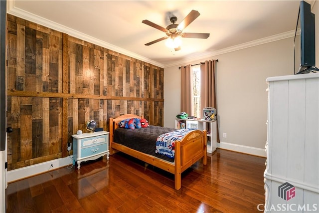 bedroom featuring dark wood-type flooring, ornamental molding, and ceiling fan