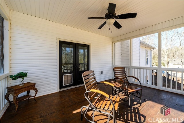 sunroom / solarium featuring ceiling fan and french doors