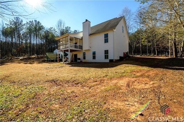 rear view of property featuring a yard