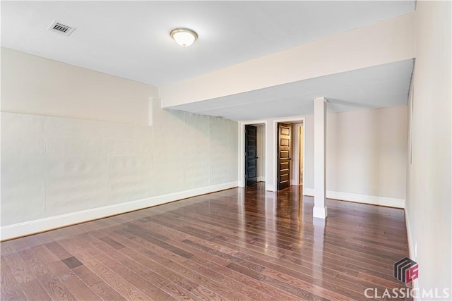 unfurnished room featuring dark wood-type flooring