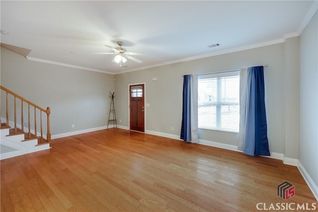 entrance foyer featuring ceiling fan, ornamental molding, and light hardwood / wood-style flooring