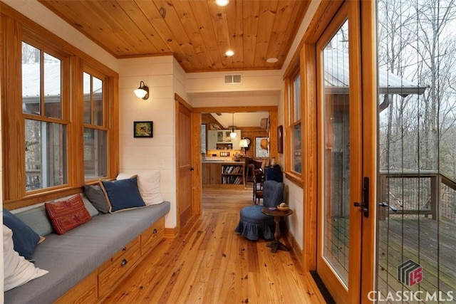 sunroom featuring french doors and visible vents