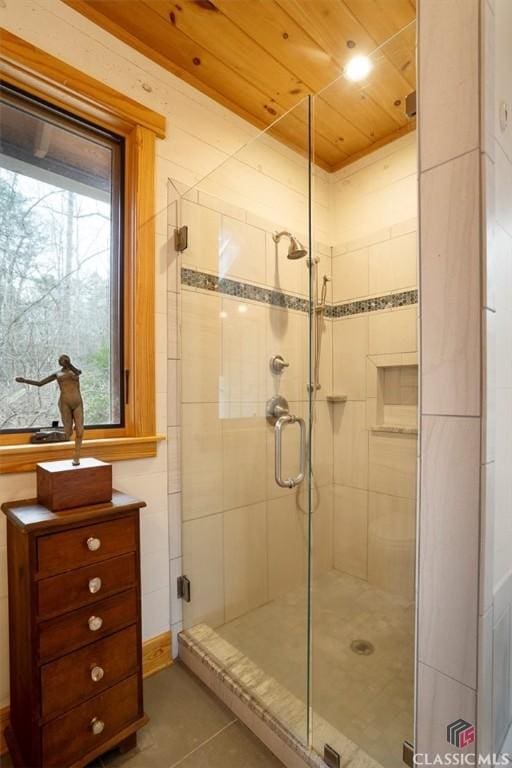 bathroom featuring a stall shower, wooden ceiling, and tile patterned flooring