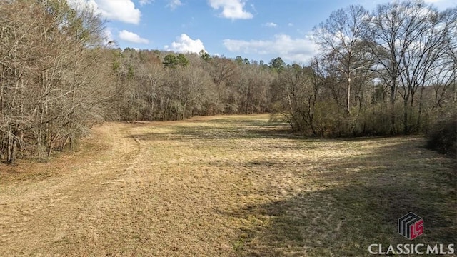 view of landscape with a wooded view
