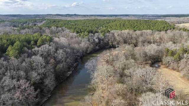 drone / aerial view featuring a view of trees