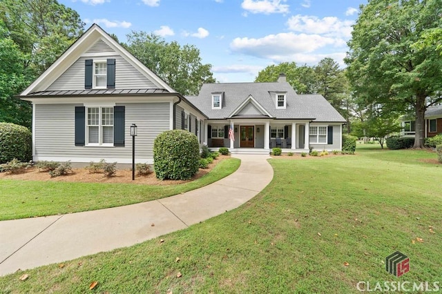 view of front of house with a front yard and covered porch